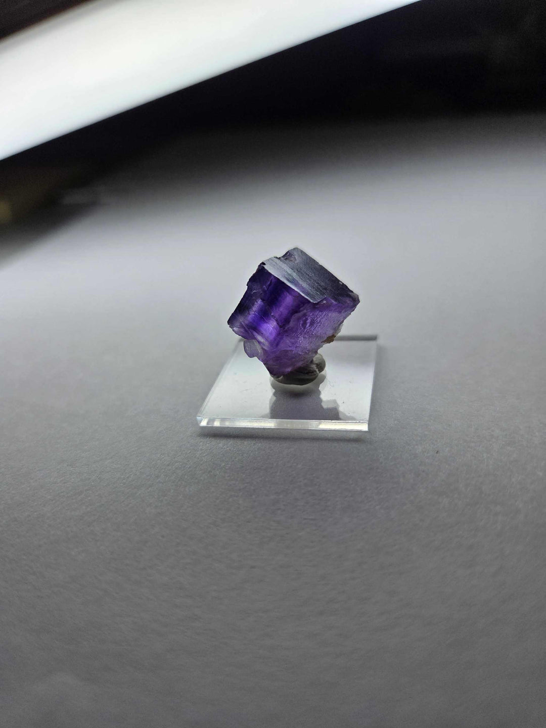 Purple Fluorite pocket specimen on clear stand for intuition and spiritual insight.