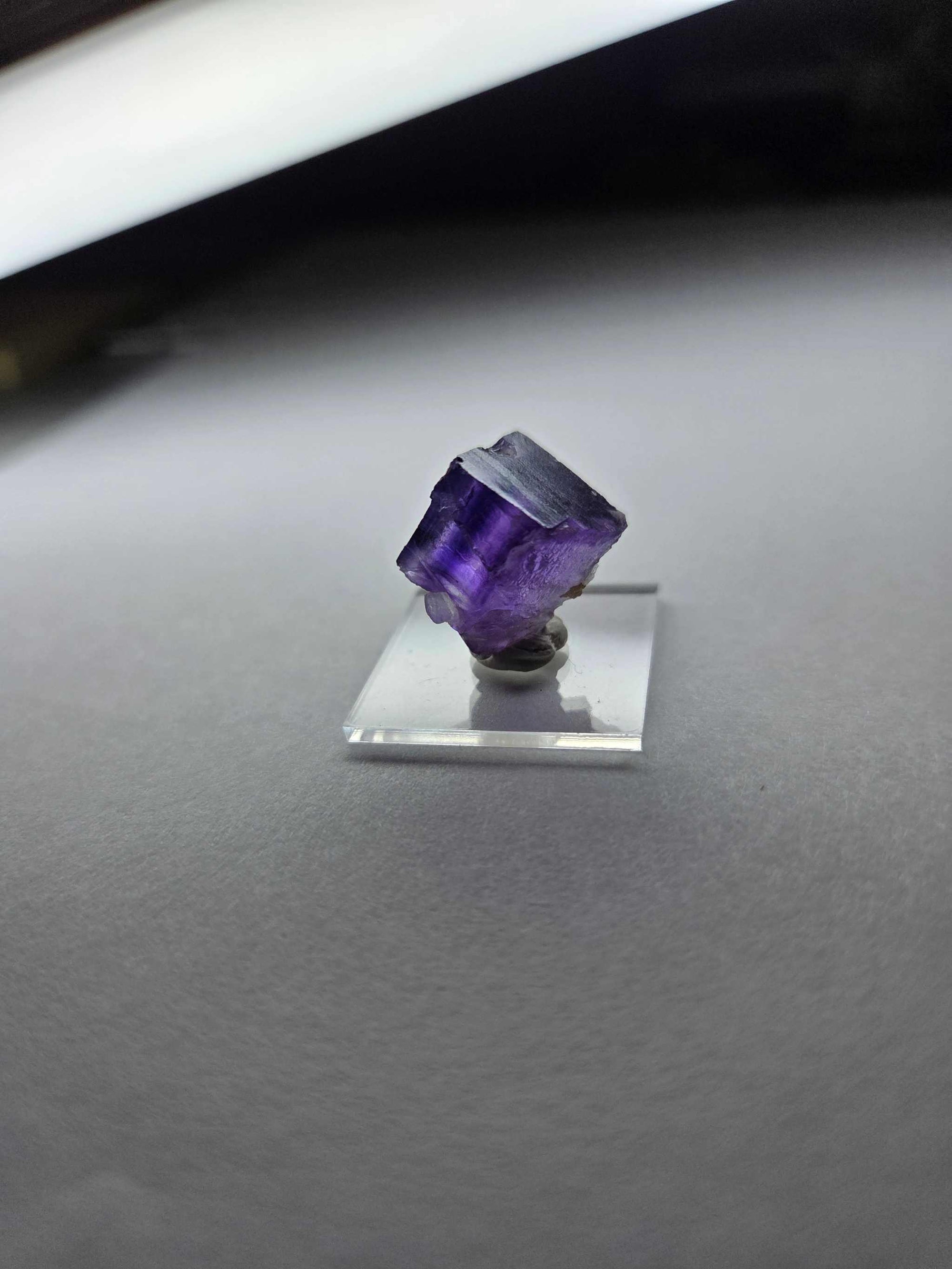 Purple Fluorite pocket specimen on clear stand for intuition and spiritual insight.
