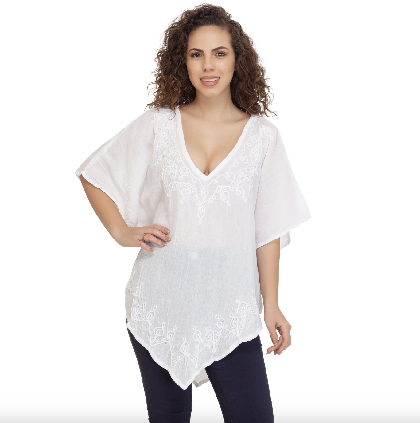 Woman wearing a beautiful white blouse with sleeves and embroidered details